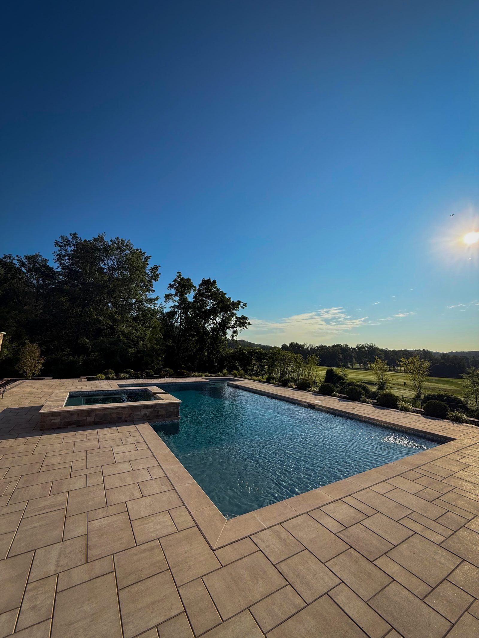 Pool with raised spa and paver patio in North Jersey